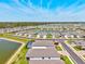 A vast community of homes, situated around a peaceful lake, creating a serene neighborhood atmosphere at 1606 Cedar Valley Dr, Port Charlotte, FL 33953