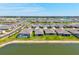 Panoramic aerial view showcasing the community layout with multiple homes surrounding a large pond at 1606 Cedar Valley Dr, Port Charlotte, FL 33953