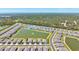 An aerial view showcases a community with a central lake and fountain features at 1606 Cedar Valley Dr, Port Charlotte, FL 33953