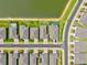 An aerial view of a planned community, featuring manicured lawns and a serene lake at 1606 Cedar Valley Dr, Port Charlotte, FL 33953