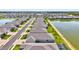 Expansive aerial view of a community with homes bordering a large pond; featuring an overview of the neighborhood at 1606 Cedar Valley Dr, Port Charlotte, FL 33953