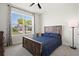 Bright bedroom with large window, furnishings, and view of the neighborhood at 1606 Cedar Valley Dr, Port Charlotte, FL 33953