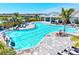Stunning community pool with ample seating, lush landscaping, and a spacious pavilion at 1606 Cedar Valley Dr, Port Charlotte, FL 33953