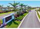Elegant entrance to The Cove at West Port featuring lush landscaping and a welcoming sign at 1606 Cedar Valley Dr, Port Charlotte, FL 33953