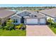 Beautiful single Gathering home with a 3 car garage, well manicured lawn, and gorgeous lake view at 1606 Cedar Valley Dr, Port Charlotte, FL 33953
