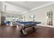 Bright game room with a pool table, comfortable seating, and a view of the outdoors at 1606 Cedar Valley Dr, Port Charlotte, FL 33953