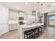 Modern kitchen with a large island, bar seating, stainless appliances and a lake view at 1606 Cedar Valley Dr, Port Charlotte, FL 33953