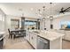 Open-concept kitchen with granite counters, stainless steel appliances and island seating at 1606 Cedar Valley Dr, Port Charlotte, FL 33953