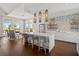 Modern kitchen and lounge area with island seating, stainless steel appliances, and stylish decor at 1606 Cedar Valley Dr, Port Charlotte, FL 33953