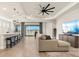 Open concept living room featuring a lake view, modern ceiling fan and tile flooring at 1606 Cedar Valley Dr, Port Charlotte, FL 33953