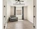 Bright office space with tray ceiling, tiled floors, large window and modern gray sofa at 1606 Cedar Valley Dr, Port Charlotte, FL 33953