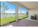 Relaxing screened patio overlooks a serene lake with lush landscaping at 1606 Cedar Valley Dr, Port Charlotte, FL 33953