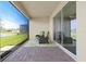 Screened lanai featuring brick flooring with picturesque lake views and green chairs at 1606 Cedar Valley Dr, Port Charlotte, FL 33953