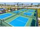 View of several outdoor pickleball courts with green and blue playing surfaces at 1606 Cedar Valley Dr, Port Charlotte, FL 33953
