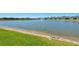 Community pond with a fountain and a sandy shore in a neighborhood of similarly-styled houses at 1606 Cedar Valley Dr, Port Charlotte, FL 33953