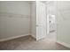 Walk-in closet area with shelving, carpet, and view of the primary bathroom at 1606 Cedar Valley Dr, Port Charlotte, FL 33953