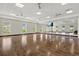 Bright and spacious yoga room featuring wood floors, large mirrors, and ample natural light at 1606 Cedar Valley Dr, Port Charlotte, FL 33953