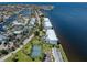 Aerial view of waterfront condominium buildings, tennis courts, and surrounding neighborhood near the bay at 1750 Jamaica Way # 322, Punta Gorda, FL 33950