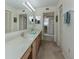 Clean bathroom with double sinks, a mirrored vanity and a walk-in shower with a glass door at 1750 Jamaica Way # 322, Punta Gorda, FL 33950