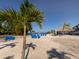 Beautiful beach scenery with blue Adirondack chairs, white sands and a beach bar for the perfect getaway at 1750 Jamaica Way # 322, Punta Gorda, FL 33950