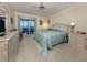 Light and airy bedroom, carpeted, with balcony access to the outside, and bright natural light at 1750 Jamaica Way # 322, Punta Gorda, FL 33950