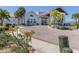 Elegant clubhouse with beautiful landscaping, circular driveway, and charming architectural details at 1750 Jamaica Way # 322, Punta Gorda, FL 33950