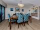 Chic dining area with a modern chandelier, bar, and inviting seating arrangement at 1750 Jamaica Way # 322, Punta Gorda, FL 33950