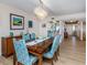 Bright dining room featuring a wooden table, seating for six, modern light fixture, and bar at 1750 Jamaica Way # 322, Punta Gorda, FL 33950