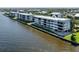 Exterior view of a waterfront condominium featuring large windows with scenic water views at 1750 Jamaica Way # 322, Punta Gorda, FL 33950