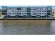 Waterfront condo exterior featuring covered parking and views of the scenic water at 1750 Jamaica Way # 322, Punta Gorda, FL 33950