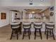 Open kitchen with granite countertops, island with seating, and stainless-steel appliances at 1750 Jamaica Way # 322, Punta Gorda, FL 33950