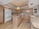 Open kitchen with island, granite countertops, stainless appliances, and ample cabinet space at 1750 Jamaica Way # 322, Punta Gorda, FL 33950