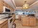 Updated kitchen with granite countertops, stainless steel appliances, and open access to living room at 1750 Jamaica Way # 322, Punta Gorda, FL 33950
