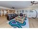 Open-concept living room with a view of the kitchen, comfortable furniture, and lots of sunlight at 1750 Jamaica Way # 322, Punta Gorda, FL 33950