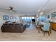 Bright, open-concept living and dining area with water views, wood floors, and modern furnishings at 1750 Jamaica Way # 322, Punta Gorda, FL 33950