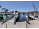 Docks with boats lined up along the marina with clear calm water on a sunny day at 1750 Jamaica Way # 322, Punta Gorda, FL 33950