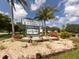 Fishermen's Village sign welcomes visitors with lush landscaping and a charming, tropical atmosphere at 1750 Jamaica Way # 322, Punta Gorda, FL 33950