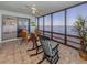 Beautiful sun room overlooking the water, tile flooring, and rocking chairs for relaxing and enjoying the view at 1750 Jamaica Way # 322, Punta Gorda, FL 33950