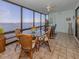 Bright sunroom featuring a view of the water, a glass dining table, and comfortable seating at 1750 Jamaica Way # 322, Punta Gorda, FL 33950