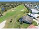 Beautiful aerial view of home on a golf course, featuring lush landscaping, screened in pool, and pristine green surroundings at 1763 Cartina Way, Venice, FL 34292