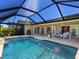 Backyard pool with screened-in lanai and covered patio perfect for entertaining and relaxing outdoors at 1763 Cartina Way, Venice, FL 34292