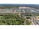 An aerial perspective of the community, featuring ponds, homes, and green spaces at 1766 Sunset Preserve Way, Port Charlotte, FL 33953