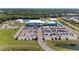 A great aerial view of the community buildings, pool, parking, and surrounding lush greenery at 1766 Sunset Preserve Way, Port Charlotte, FL 33953