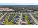 An aerial view showcases the home nestled in a well-planned community and views of surrounding natural areas at 1766 Sunset Preserve Way, Port Charlotte, FL 33953