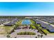 Aerial view of a community with a central water feature and playground in the middle of the neighborhood at 1766 Sunset Preserve Way, Port Charlotte, FL 33953