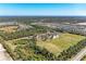 An aerial view highlighting community sports facilities, including soccer fields and baseball diamonds at 1766 Sunset Preserve Way, Port Charlotte, FL 33953