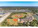 An aerial shot of baseball and softball fields surrounded by lush greenery, creating a recreational haven at 1766 Sunset Preserve Way, Port Charlotte, FL 33953