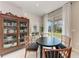 Cozy dining area with table and chairs next to bright window and cabinet at 1766 Sunset Preserve Way, Port Charlotte, FL 33953