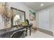 The foyer showcases a console table with elegant decor and painting, and tiled flooring at 1766 Sunset Preserve Way, Port Charlotte, FL 33953