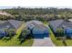 Aerial view of the house displaying the roof, landscaping, and gray brick driveway at 1766 Sunset Preserve Way, Port Charlotte, FL 33953